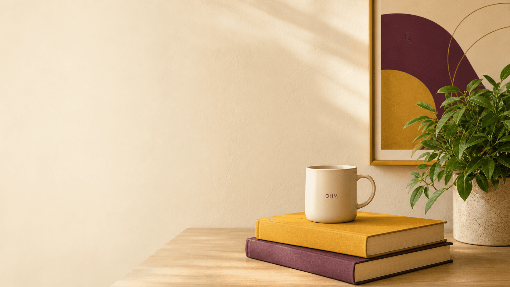 A warm learning desk with books, an OHM mug, and a plant